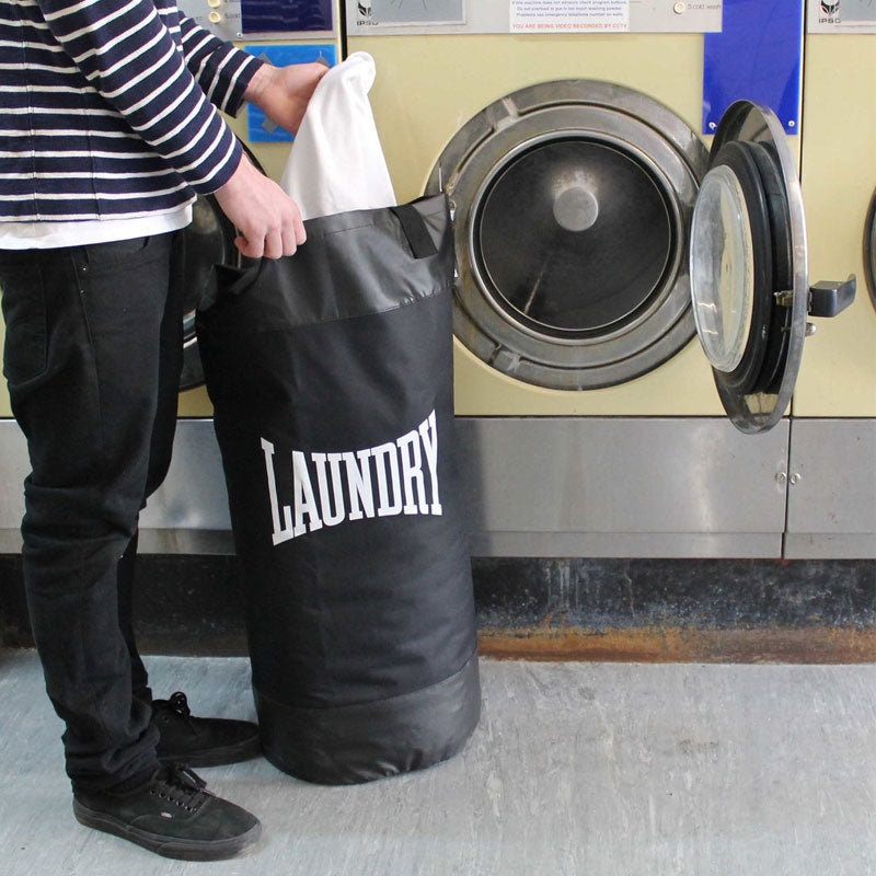 סל כביסה שחור מעוצב בצורת שק איגרוף עם כיתוב לבן